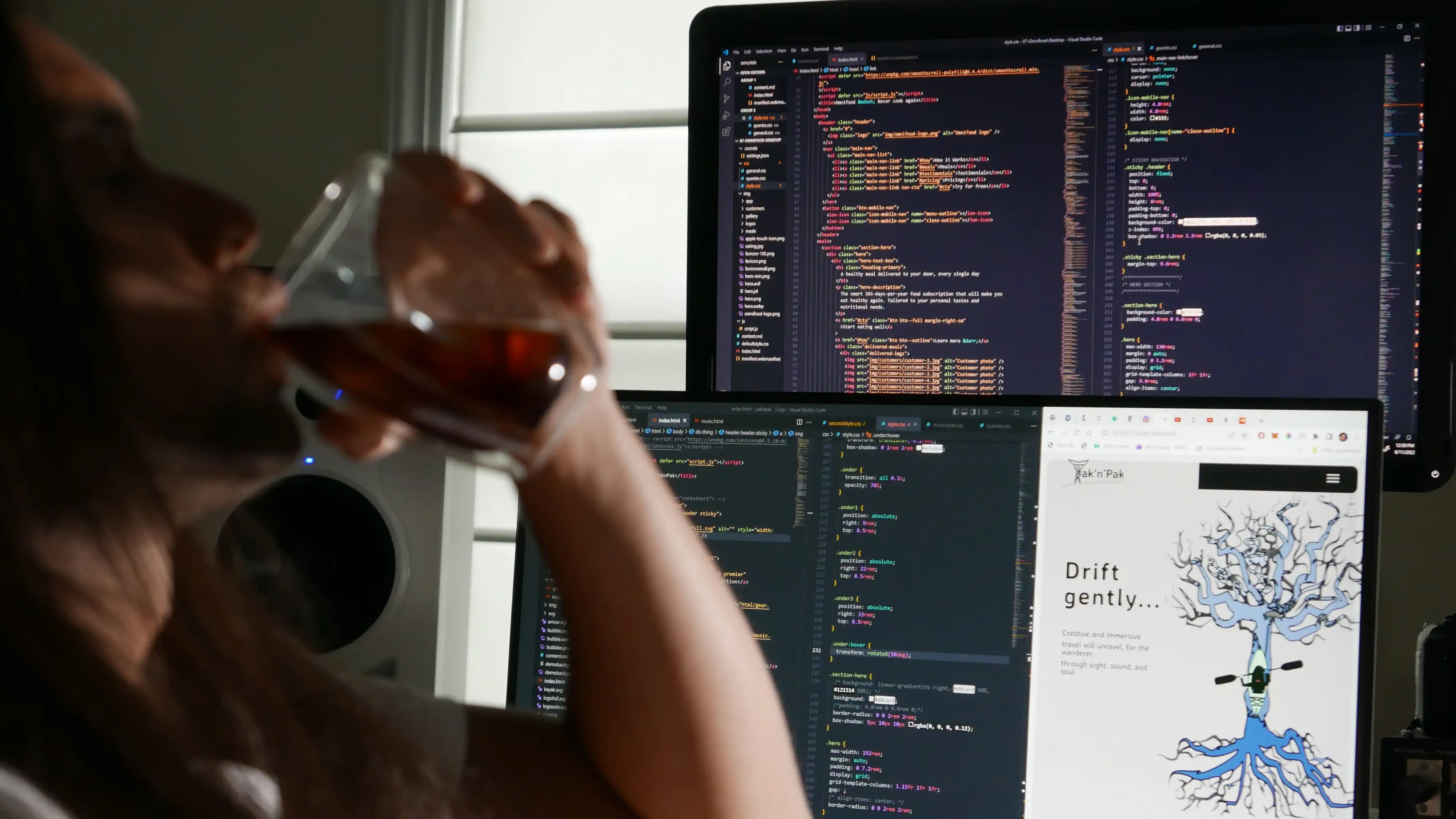 man drinking coffee in front of a computer