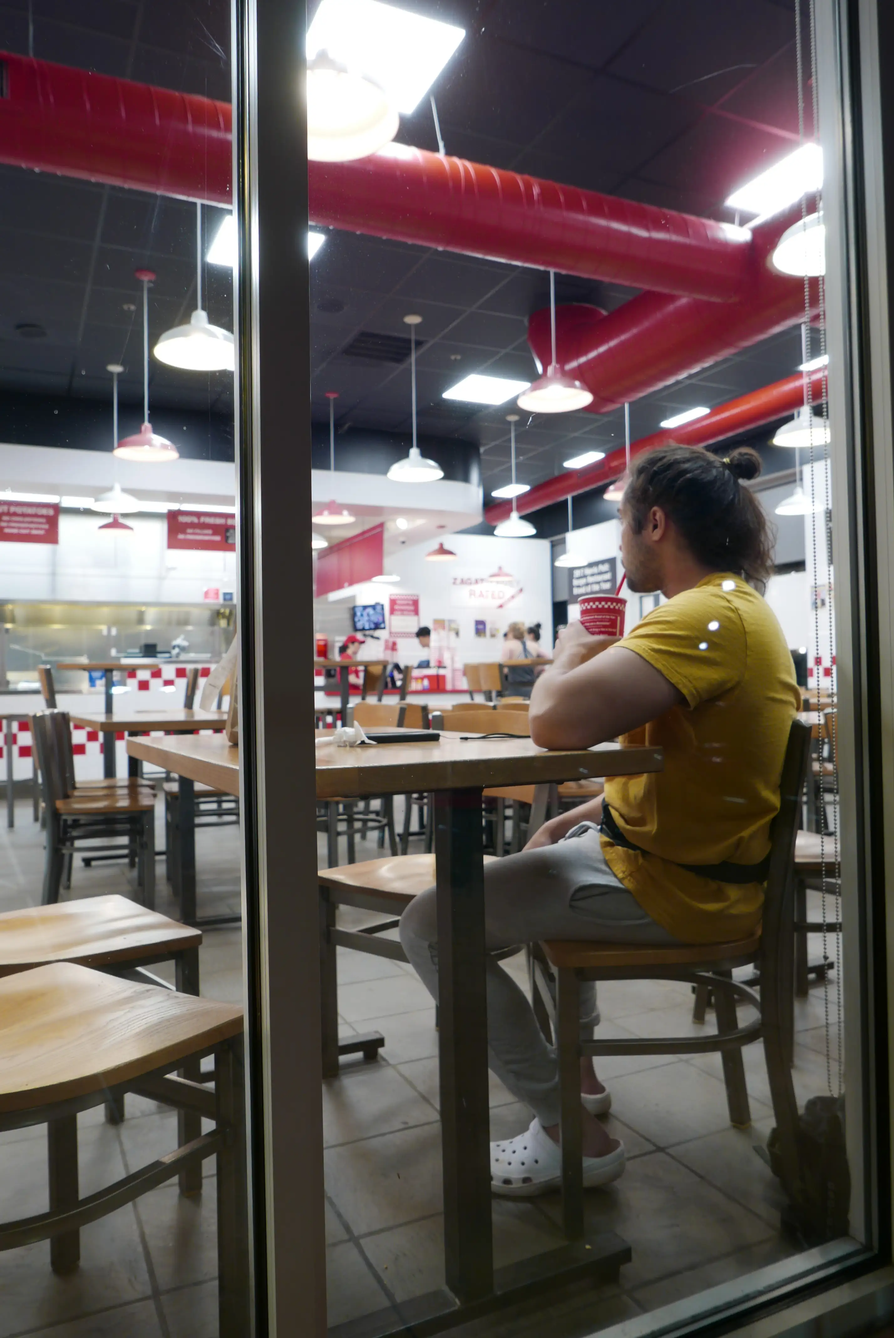 man drinking coffee in front of a computer